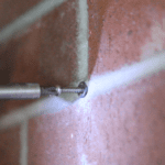 screw in brick wall