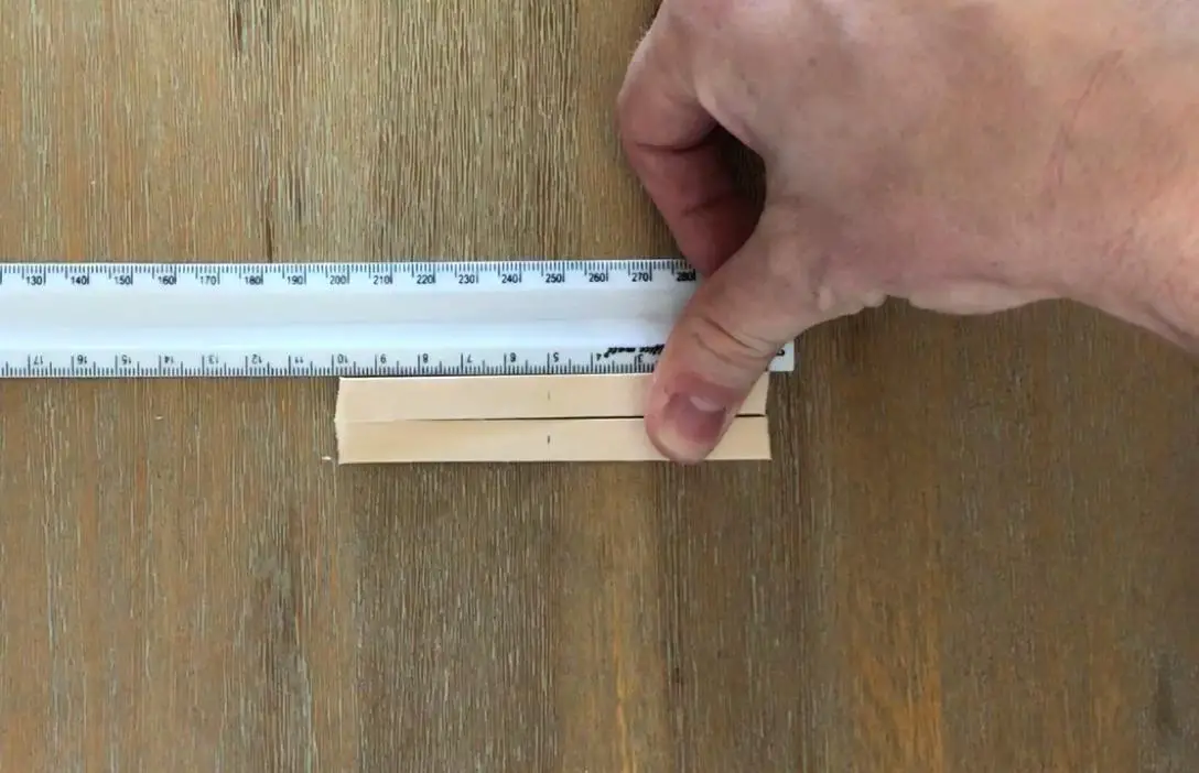 mark the centre of the popsicle sticks