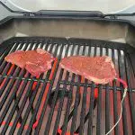 Steaks Seasoned and Cooking on Weber Pulse 2000