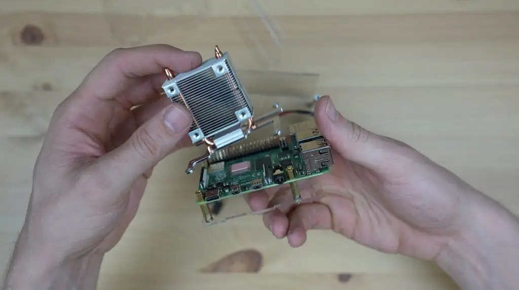 Heat Sink Being Installed On Raspberry Pi